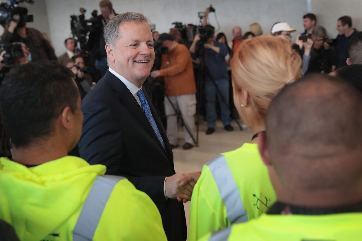 American Airlines CEO Doug Parker greets workers at a ceremony to mark the opening of five new gates at O'Hare International Airport in Chicago, Ill., on May 11, 2018. (Scott Olson/Getty Images)