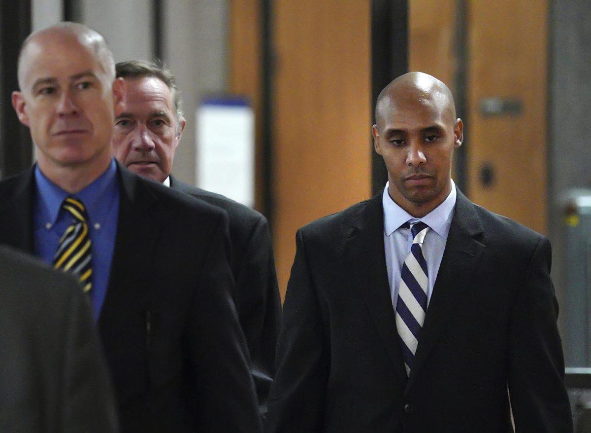 Former Minneapolis police officer Mohamed Noor (R), with attorneys Peter Wold (C) and Thomas Plunkett (L), walks out of the the Hennepin County Government Center on April 25, 2019. (Brian Peterson/Star Tribune/AP)