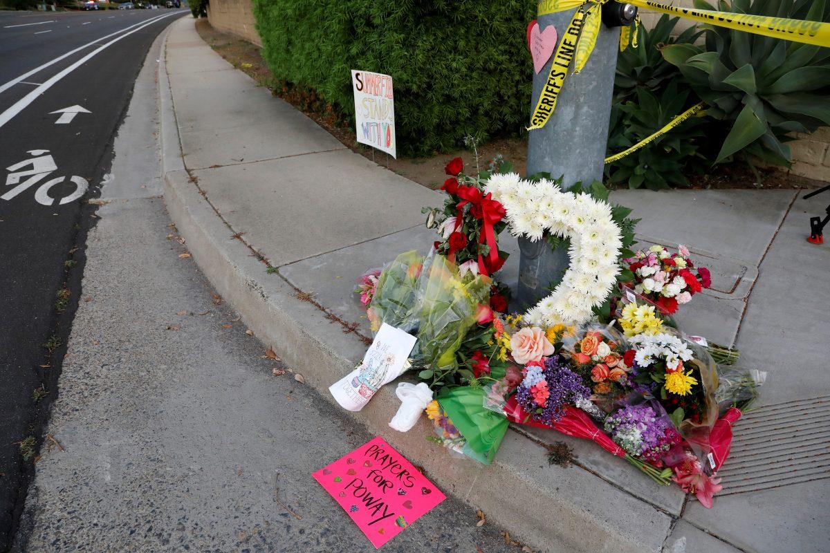 A makeshift memorial was placed by a light pole a block away from a shooting incident where one person was killed at the Congregation Chabad synagogue in Poway, north of San Diego, Calif., on April 27, 2019. (John Gastaldo/Reuters)