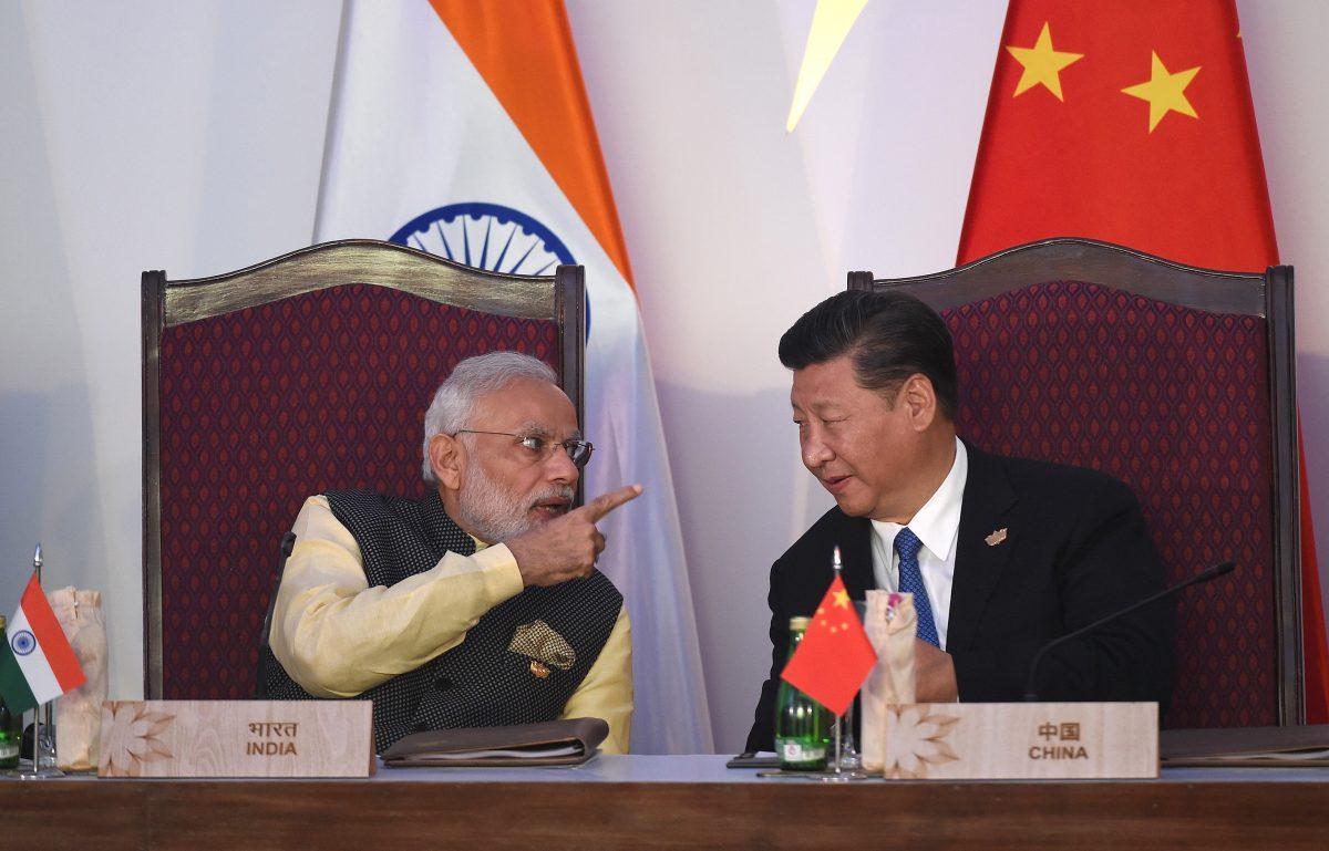 India Prime Minister Narendra Modi (L) gestures while talking with Chinese leader Xi Jinping during the BRICS leaders' meeting with the BRICS Business Council at the Taj Exotica hotel in Goa, India, on Oct. 16, 2016. (Prakash Singh/AFP/Getty Images)