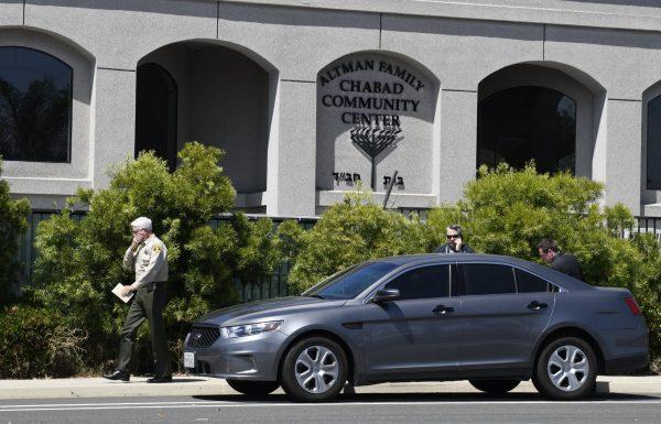 San Diego County Sheriff Bill Gore, left, walks past the Chabad of Poway Synagogue in Poway, Calif., on April 27, 2019. (Denis Poroy/Photo via AP)