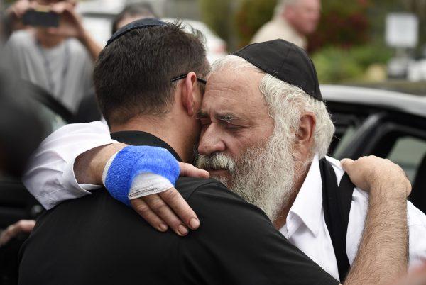 Rabbi Yisroel Goldstein, right, is hugged as he leaves a news conference at the Chabad of Poway synagogue in Poway, Calif., on April 28, 2019. (Denis Poroy/AP Photo)