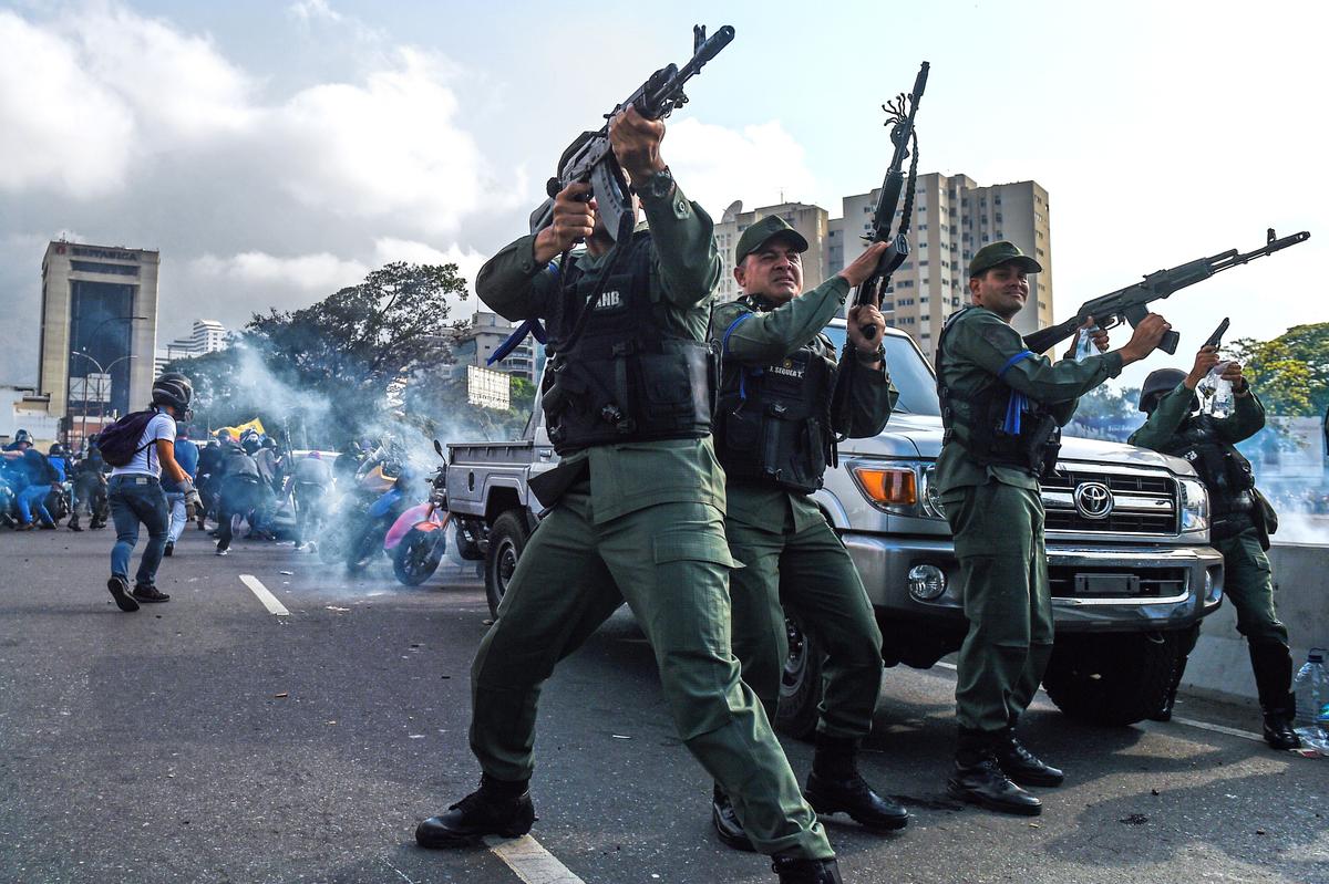 Members of the Bolivarian National Guard who joined Venezuelan interim President Juan Guaidó fire into the air to repel forces loyal to dictator Nicolás Maduro who arrived to disperse a demonstration near La Carlota military base in Caracas on April 30, 2019. (Federico Parra/AFP/Getty Images)
