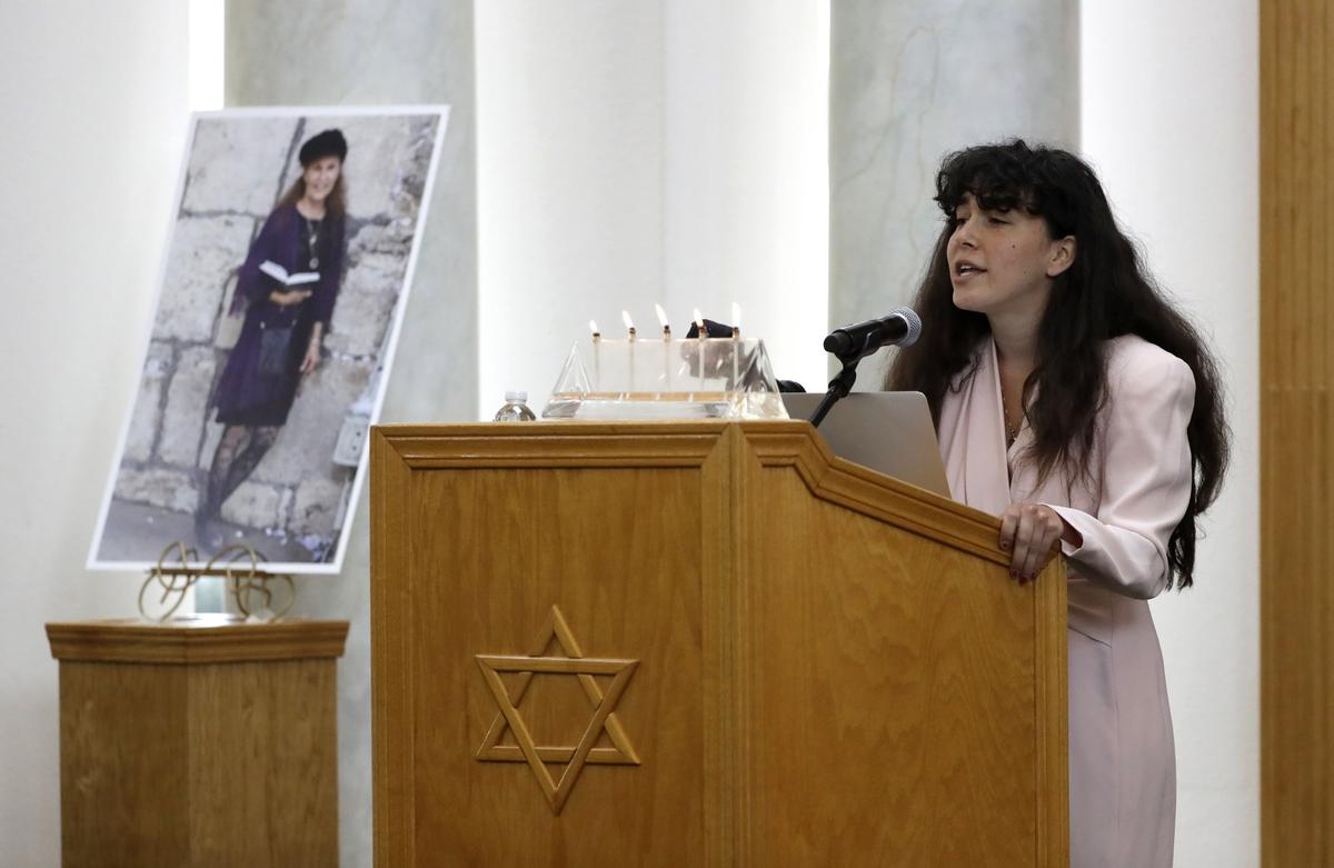 A photo of Lori Kaye, a victim of the synagogue shooting, is displayed in the Chabad synagogue as her daughter Hannah speaks during Kaye's funeral in Poway, Calif., on April 29, 2019. (Gregory Bull/The Associated Press)
