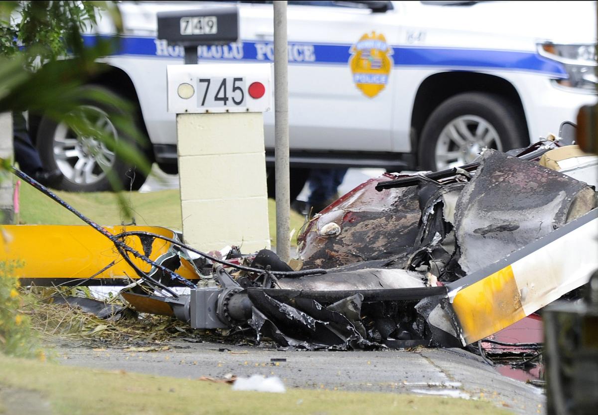 The wreckage of a helicopter lies on the street after crashing in Kailua, Hawaii, on April 29, 2019. (Bruce Asato/Honolulu Star-Advertiser via The Associated Press)