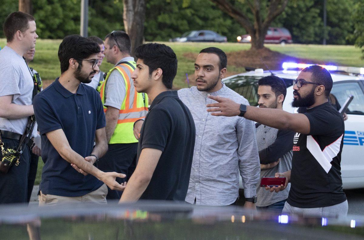 People gather across from the campus of University of North Carolina at Charlotte after a shooting at the school on April 30, 2019, in Charlotte, N.C. (Jason E. Miczek/Photo via AP)