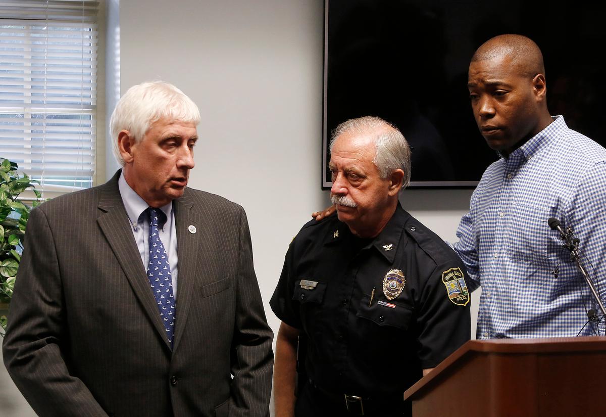 Virginia Beach Mayor Bobby Dyer, left, looks on as City Councilman Aaron Rouse, right, comforts Chief of Police James Cervera following a press conference, in Virginia Beach, Va. on May 31, 2019. (Kaitlin McKeown/The Virginian-Pilot via AP)