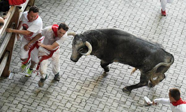 Participants run next to a fighting bull on the third day of the San Fermin bull run festival in Pamplona, northern Spain, on July 9, 2018. (Jose Jordan/AFP/Getty Images)