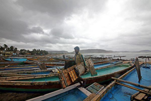 A fisherman carries his tools as he leaves for a safer place after tying his boats along the shore ahead of cyclone Fani in Peda Jalaripeta on the outskirts of Visakhapatnam, India, on May 1, 2019. (Stringer/Reuters)