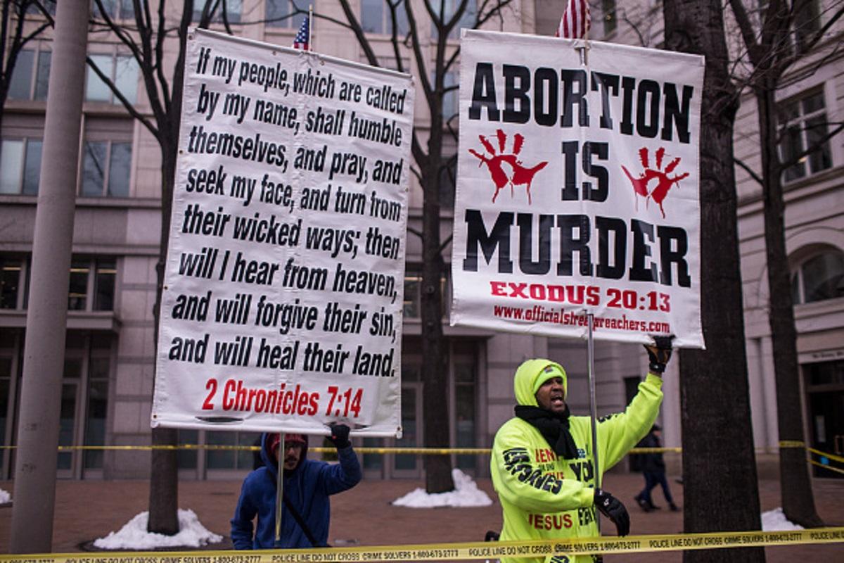 Anti-abortion protestors hold signs near Freedom Plaza during the 2019 Women's March in Washington, on Jan. 19, 2019. (Zach Gibson/Getty Images)