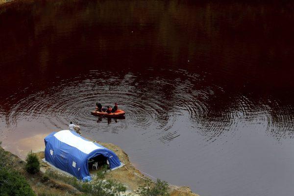 Members of the Cyprus Special Disaster Response Unit search for suitcases in a man-made lake, near the village of Mitsero outside of the capital Nicosia, Cyprus, on May 1, 2019. (Petros Karadjias/Photo via AP)
