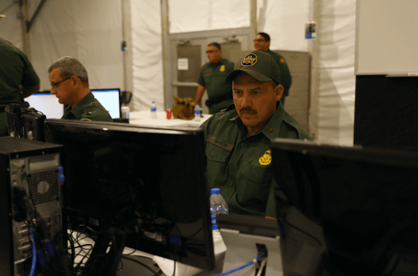 A Border Patrol agent works at a terminal for intake and processing at the new Border Patrol tent facility for holding illegal immigrants in Donna, Texas, on May 2, 2019. (Charlotte Cuthbertson/The Epoch Times)