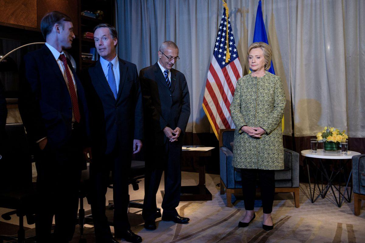 Clinton advisers Jake Sullivan (L), Nick Burns (2L), and John Podesta (2R) wait with Clinton campaign Chairman, Democratic presidential nominee Hillary Clinton for a meeting with Ukrainian President Petro Poroshenko in New York on Sept. 19, 2016. (Brendan Smialowski/AFP/Getty Images)