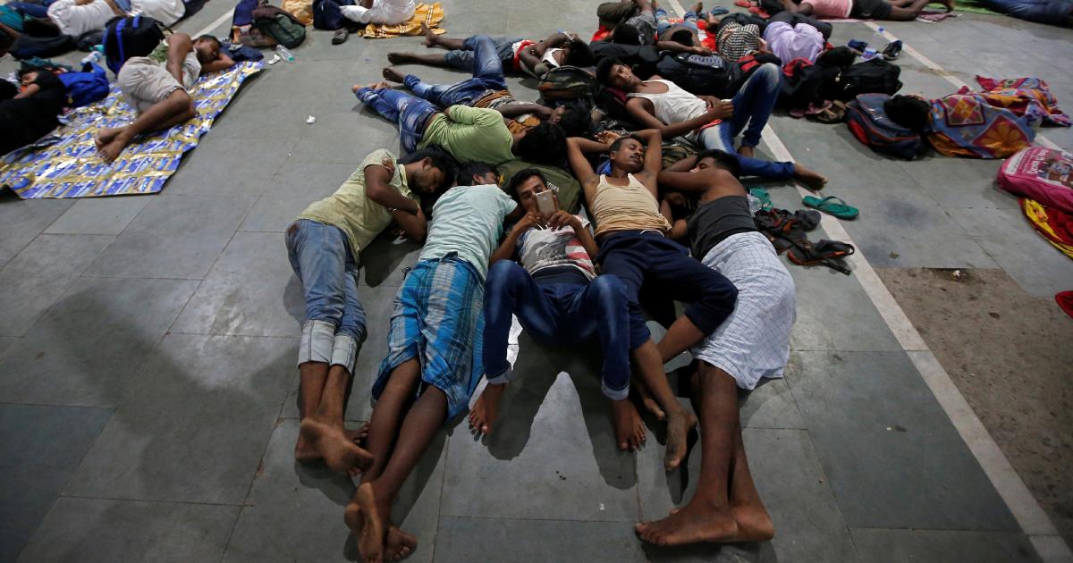 Stranded passengers rest inside a railway station after trains between Kolkata and Odisha were cancelled ahead of Cyclone Fani, in Kolkata, India, May 3, 2019. (Rupak De Chowdhuri/Reuters)