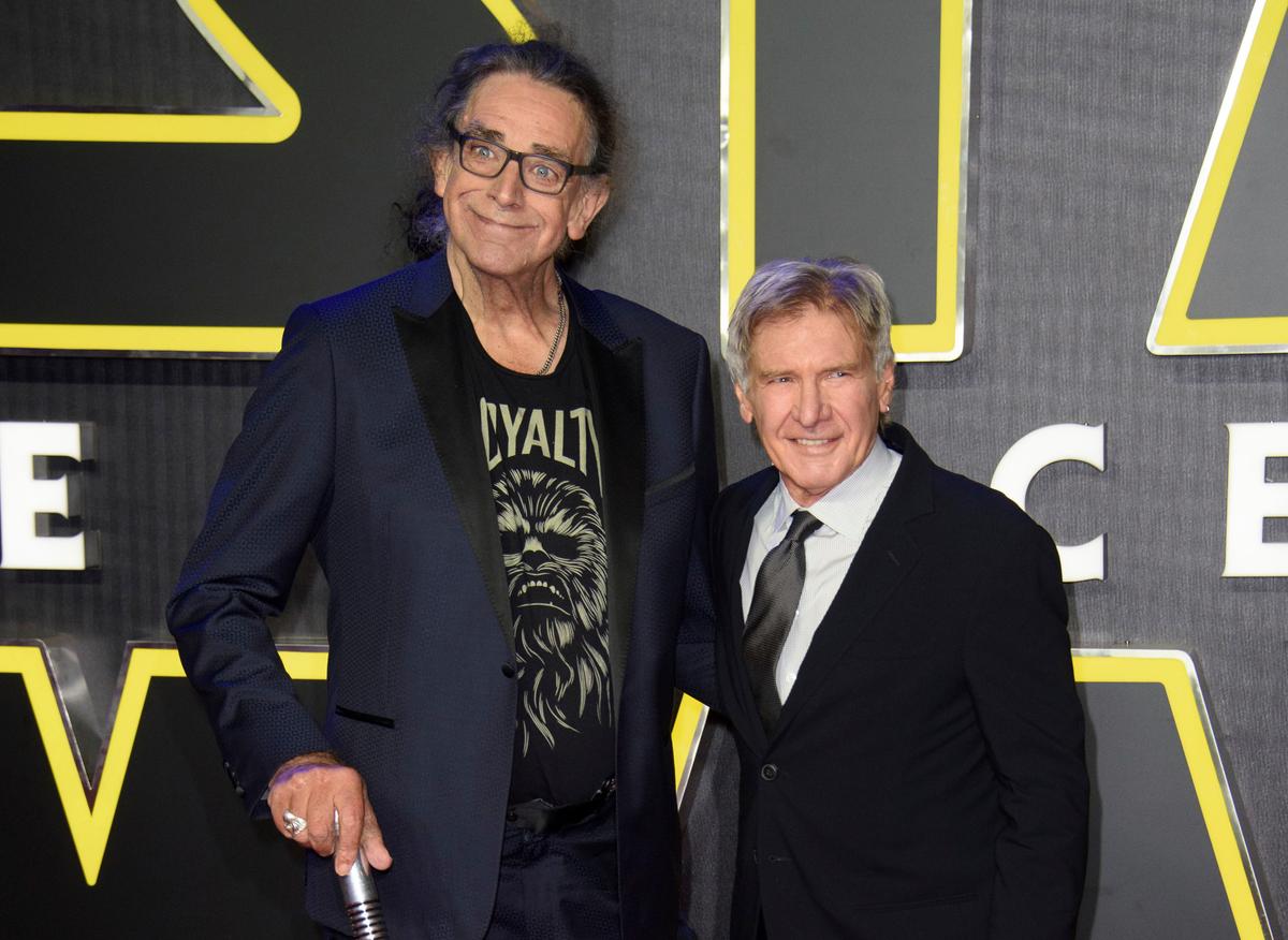 This Dec. 16, 2015, file photo shows Peter Mayhew, left, and Harrison Ford at the European premiere of the film "Star Wars: The Force Awakens" in London. (©AP | Jonathan Short)