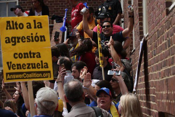 Supporters of Venezuelan interim president Juan Guaidó block a back entrance of the Embassy of Venezuela May 2, 2019 in Washington, DC. Guaidó supporters tried to evict dozens of activists who have been occupying the embassy in order to protect the building from losing control after illegitimate dictator Nicolas Maduro closed the embassy in January 2019. (Alex Wong/Getty Images)
