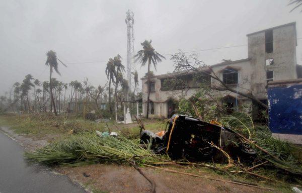 An auto-rickshaw and uprooted trees lie along a road in Puri district after Cyclone Fani hit the coastal eastern state of Odisha, India, on May 3, 2019. (AP Photo)