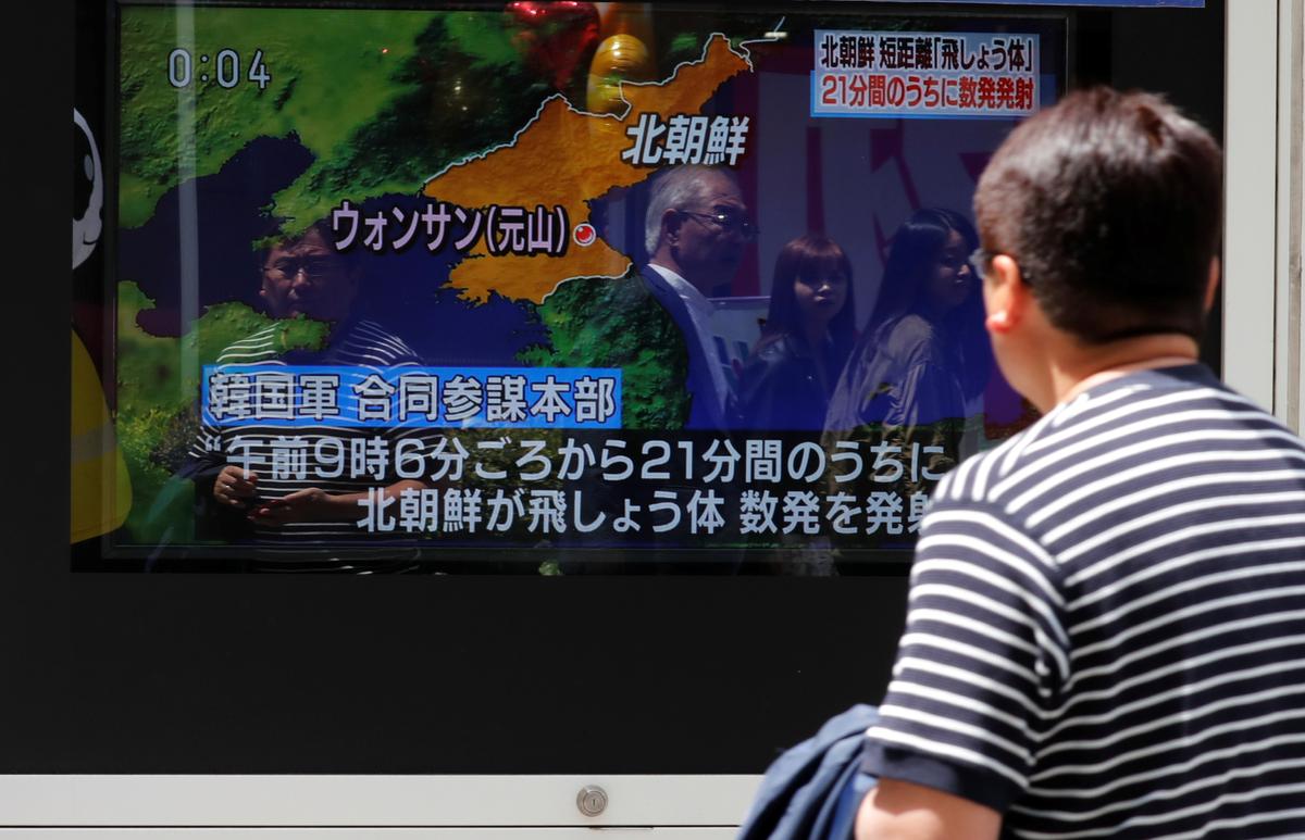 A man watches a television screen showing a news report on North Korea firing several short-range projectiles from its east coast, on a street in Tokyo, Japan, on May 4, 2019. (Reuters/Kim Kyung-Hoon)