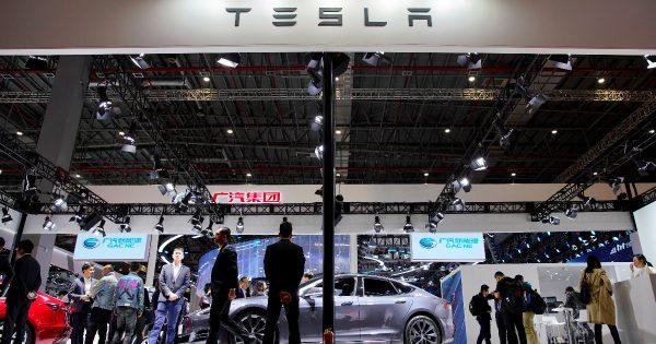 People visit a Tesla booth during the media day for the Shanghai auto show in Shanghai, China, on April 16, 2019. (Aly Song/Reuters)