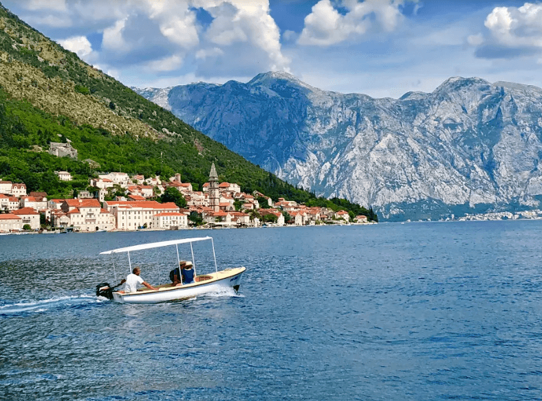 A boat cruises past Perast in the Bay of Kotor. (Tim Johnson)