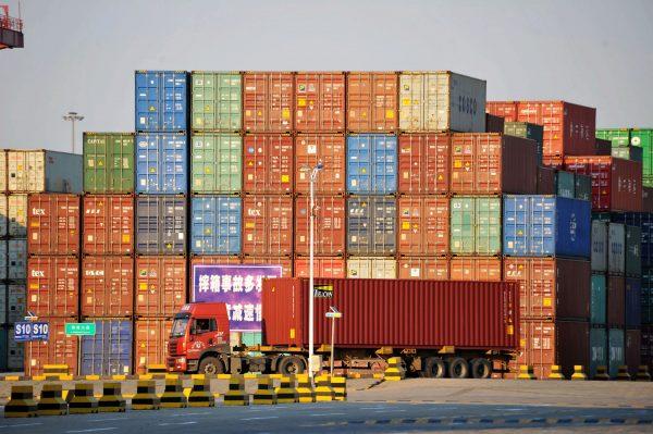 A truck transports a shipping container at Qingdao port in Shandong Province, China on Oct. 12, 2018. (China Daily/via Reuters)