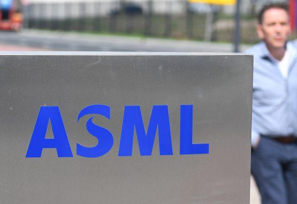 An employee walks past an ASML logo, a Dutch company, which is currently the largest supplier in the world of semiconductor manufacturing machines, at the company's headquarters in Veldhoven on April 17, 2018. (EMMANUEL DUNAND/AFP/Getty Images)