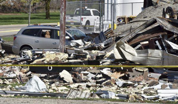 Vehicles are covered by rubble at the scene of an explosion at AB Specialty Silicones on Sunset Ave. and Northwestern Ave. on the border between Gurnee, Ill., and Waukegan. (John Starks/Daily Herald via AP)