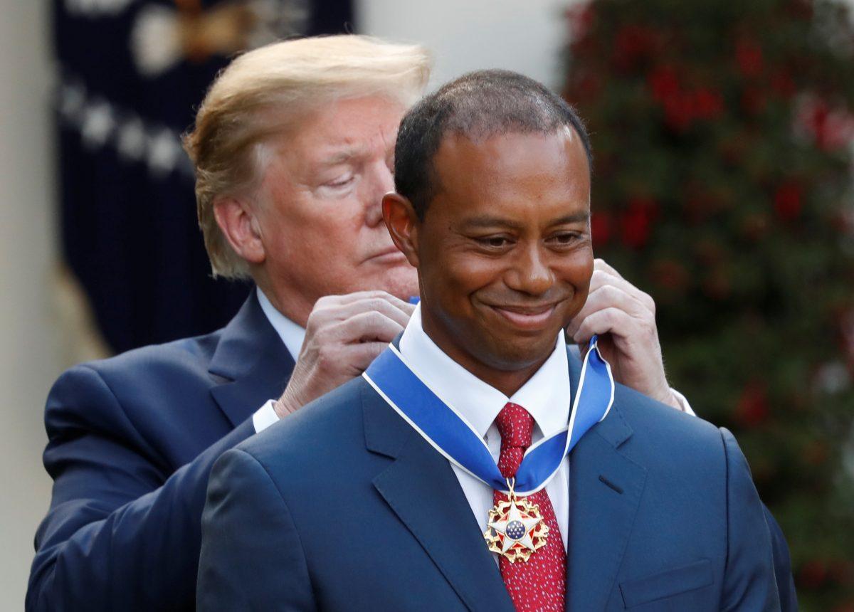 President Donald Trump hangs the Presidential Medal of Freedom around Golf Champion Tiger Woods' neck at the White House Rose Garden in Washington, on May 6, 2019. (Kevin Lamarque/Reuters)