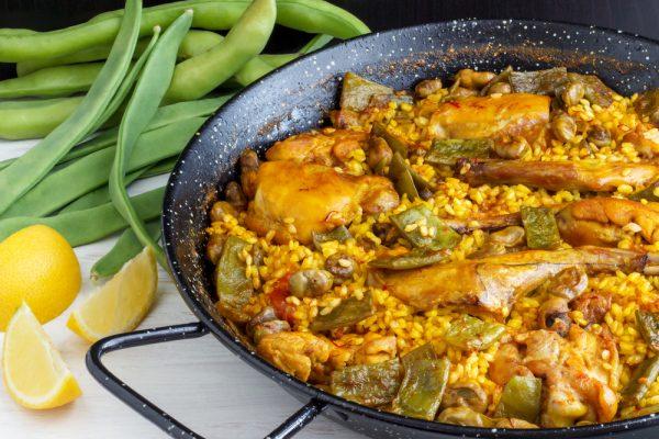 Elaborate versions of paella now abound, but the original paella Valenciana is a simple dish, made with seasonal vegetables and meats like chicken, rabbit, and duck. (Shutterstock)