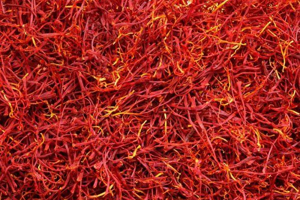 Saffron gives paella its golden hue and earthy, honeyed flavor. Look for deep red stems with lighter orange-yellow tips; a solid red color is a sign of lower-quality saffron that has been dyed. (Shutterstock)