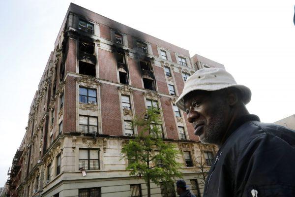 Leon Black, a resident of building burned in a fire, visits the scene in New York's Harlem neighborhood on May 8, 2019. (Richard Drew/Photo via AP)