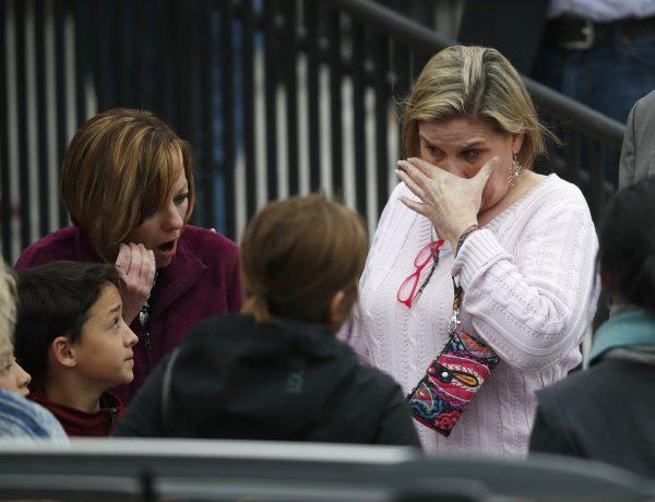 Parents fight back tears as they wait for their children at a recreation center where students were reunited with their parents in Highlands Ranch, Colo., on May 7, 2019. (David Zalubowski/AP)