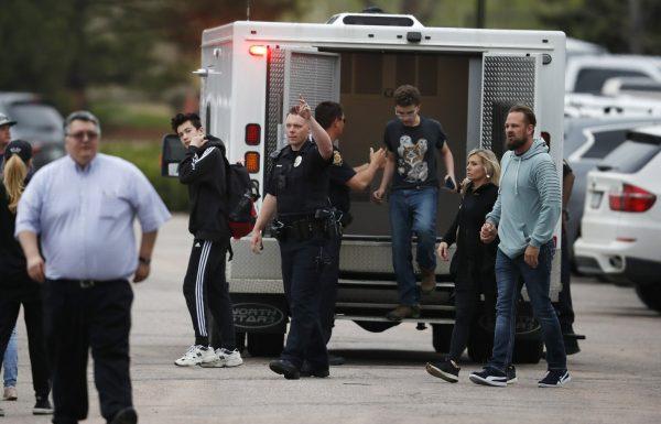 Students exit an ambulance at a recreation center for students to get reunited with their parents after a shooting at a suburban Denver middle school in Highlands Ranch, Colo. on May 7, 2019. (David Zalubowski/AP)