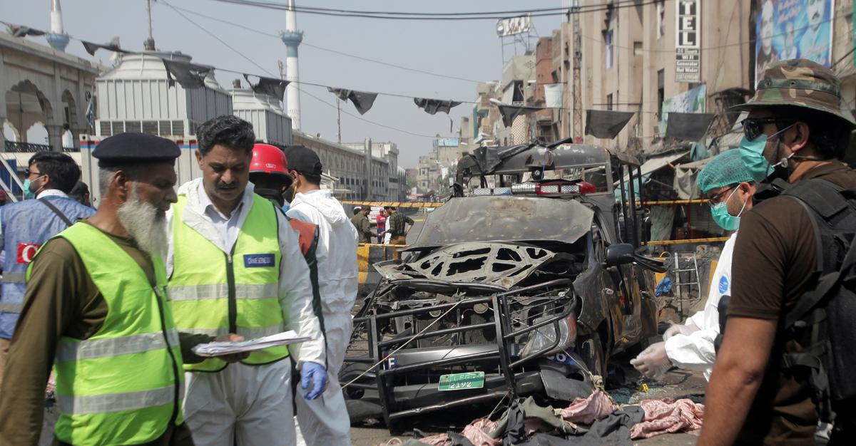 Security officials and members of a bomb disposal team survey the site after a blast in Lahore, Pakistan May 8, 2019. (Mohsin Raza/Reuters)