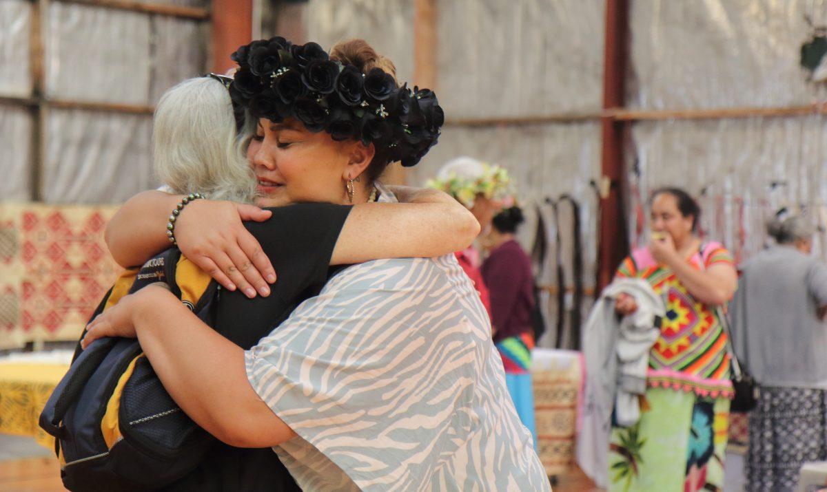 Jarcinda Stowers-Ama hugs a member of the public. Events like the Tuvalu Arts Festival are open to the public to learn about Pacific Island life. (Lorraine Ferrier/The Epoch Times)