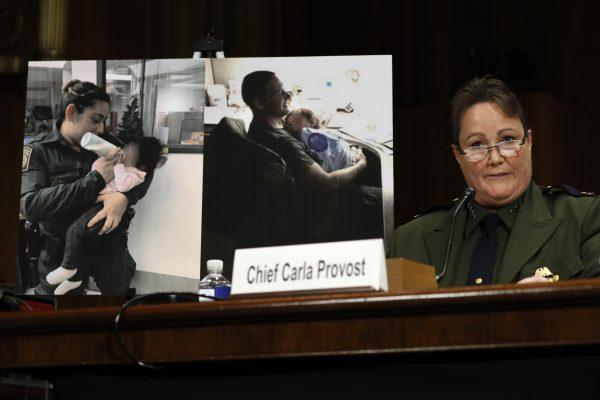 U.S. Border Patrol Chief Carla Provost testifies by a photo of agents with children during a Senate Judiciary Border Security and Immigration Subcommittee hearing about the border, on Capitol Hill in Washington, on May 8, 2019. (Jacquelyn Martin/AP Photo)