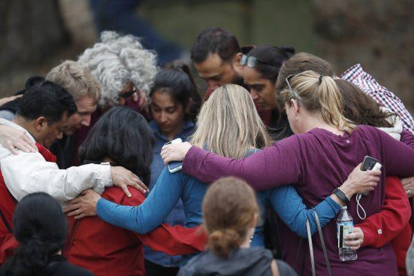 Parents gather in a circle to pray at a recreation center where students were reunited with their parents after a shooting at a suburban Denver middle school Tuesday, May 7, 2019, in Highlands Ranch, Colo. (David Zalubowski/AP Photo)