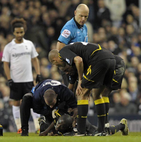 Referee Howard Webb looks on as Fabrice Muamba is treated by medical staff at White Hart Lane in north London after collapsing during a match on March 17, 2012. (Olly Greenwood/AFP/Getty Images)