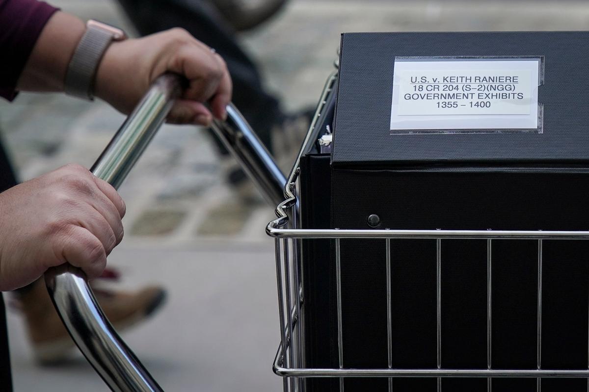 Staff and members of the prosecution team push carts full of court documents related to the U.S. v. Keith Raniere case as they arrive at the U.S. District Court for the Eastern District of New York in the Brooklyn borough of New York City on May 7, 2019. (Drew Angerer/Getty Images)