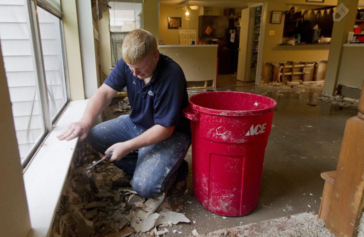 Jay Dabravio removes drywall from his flooded house in the Sherwood Trail subdivision in Kingwood, Texas on May 8, 2019. (Jason Fochtman/Houston Chronicle via AP)