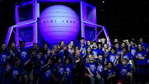 Founder, Chairman, CEO and President of Amazon Jeff Bezos poses with children from 'Club of the Future' after his space company Blue Origin's space exploration lunar lander rocket called Blue Moon was unveiled at an event in Washington, on May 9, 2019. (Clodagh Kilcoyne/Reuters)