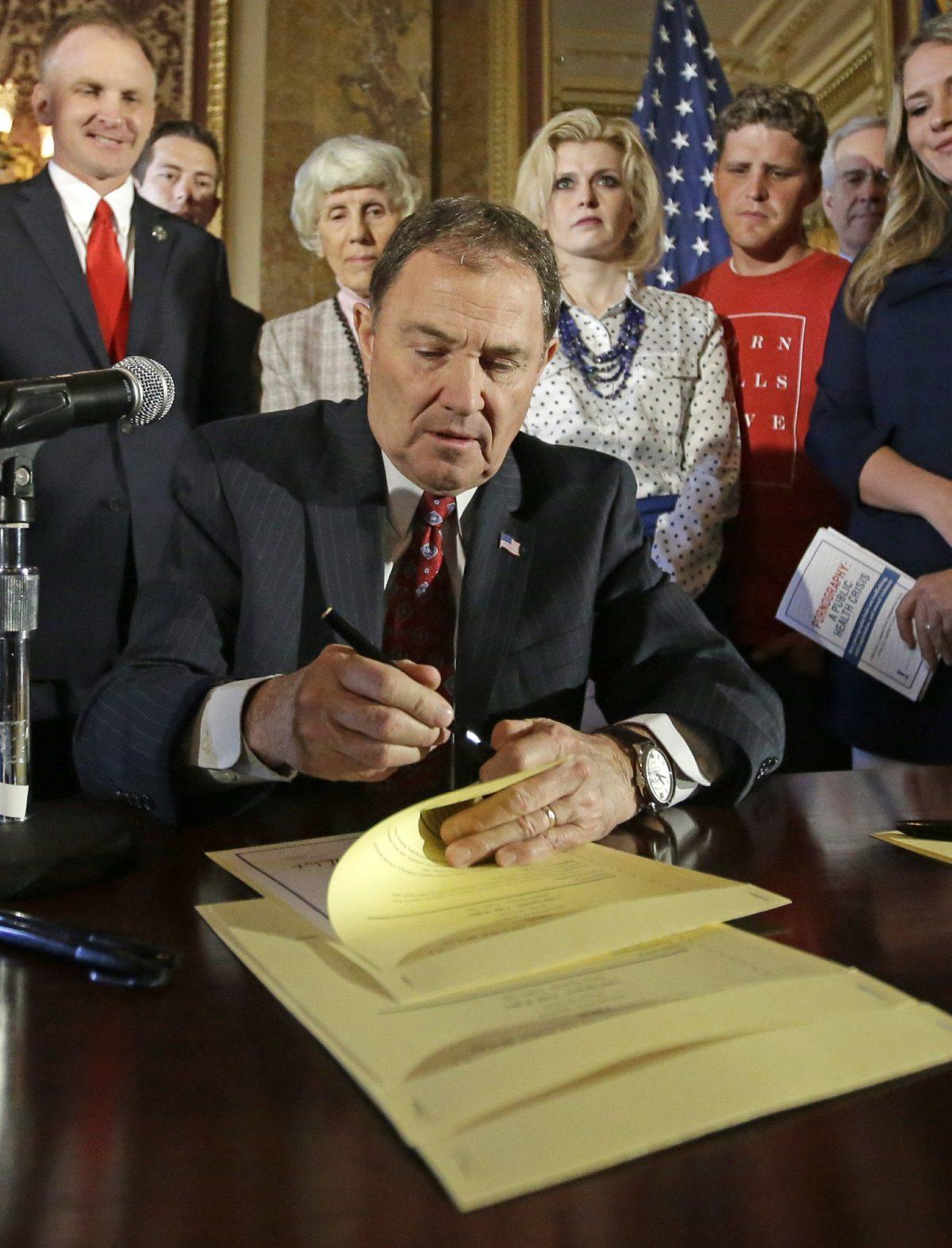 Utah Gov. Gary Herbert looks up during a ceremonial signing of a state resolution declaring pornography a public health crisis, at the Utah State Capitol, in Salt Lake City, on April 19, 2016. (Rick Bowmer/AP Photo)