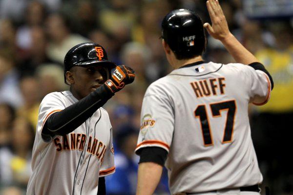 Joaquin Arias #13 of the San Francisco Giants high-fives Aubrey Huff (R) #17 after hitting a two-run homer in the top of the fourth inning against the Milwaukee Brewers at Miller Park in Milwaukee, Wis., on May 22, 2012. (Mike McGinnis/Getty Images)