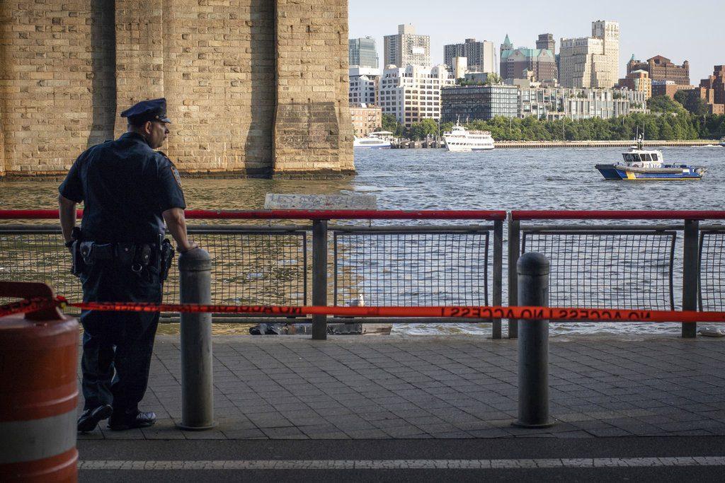 A New York Police Department officer stands guard as authorities investigate the death of a baby boy who was found floating in the East River near the Brooklyn Bridge in the Manhattan borough of New York on Aug. 5, 2018. (Robert Bumsted/AP Photo)
