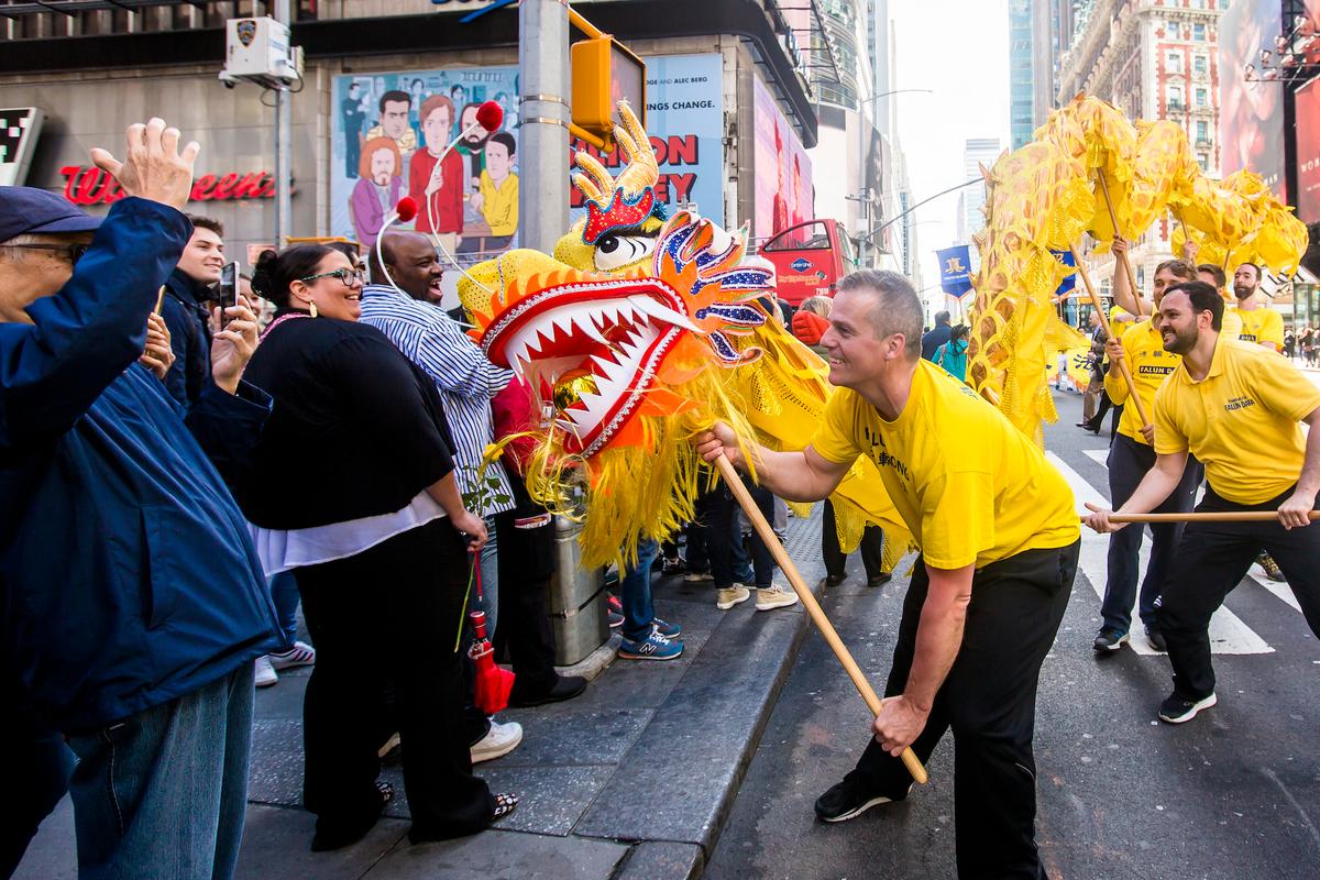 A Falun Gong lion dance team joins thousands of Falun Gong practitioners from all over the world to march in a parade along 42nd Street in New York for World Falun Dafa Day on May 12, 2017. (©The Epoch Times | Samira Bouaou)