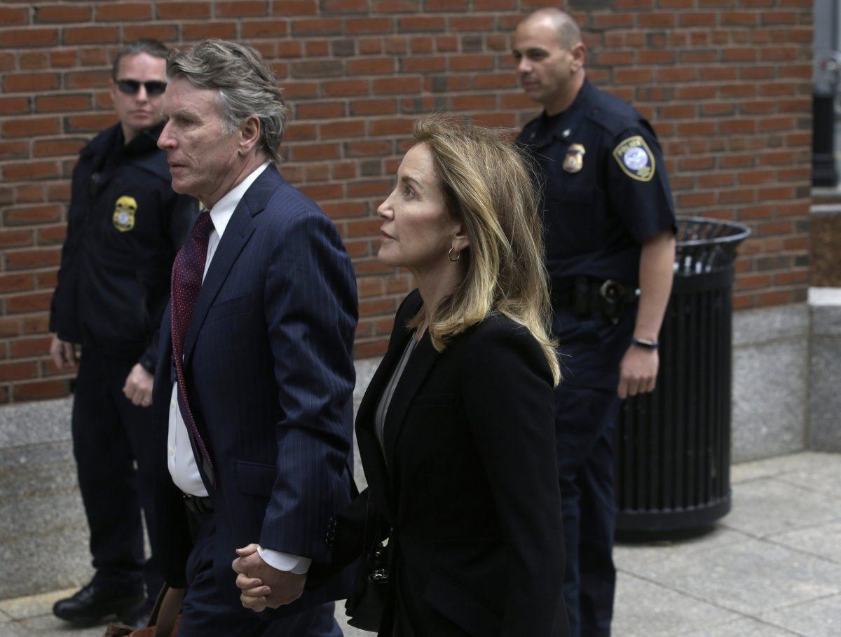 Actress Felicity Huffman arrives with her brother Moore Huffman Jr., at federal court in Boston, where she is scheduled to plead guilty to charges in a nationwide college admissions bribery scandal, on May 13, 2019. (Steven Senne/AP Photo)