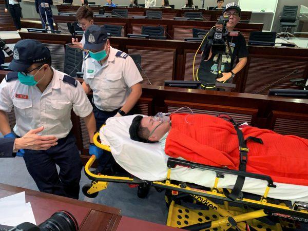 Pro-democracy lawmaker Gary Fan is carried away on a stretcher after clashes with pro-Beijing lawmakers during a meeting for control of a meeting room to consider the controversial extradition bill, in Hong Kong, China on May 11, 2019. (James Pomfret/Reuters)