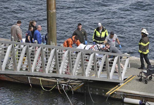 Emergency response crews transport an injured passenger to an ambulance at the George Inlet Lodge docks, in Ketchikan, Alaska on May 13, 2019. (Safranek/Ketchikan Daily News via AP)