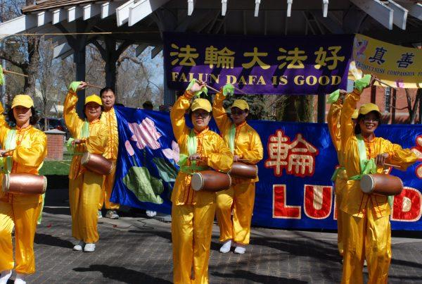 Falun Gong adherents perform a waist drum dance during the International Falun Dafa Day celebration in Edmonton on May 11, 2019. (Pingsan Qu/The Epoch Times)