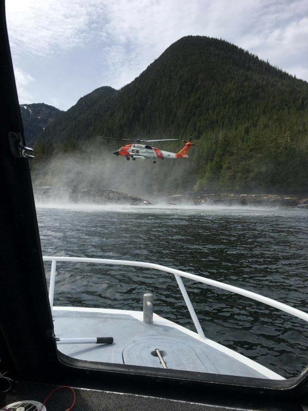 A Coast Guard Air Station Sitka MH-60 Jayhawk helicopter crew hovers while searching for a survivor from a report of two aircraft colliding in the vicinity of George Inlet near Ketchikan, Alaska on May 13, 2019. (Ryan Sinkey/U.S. Coast Guard/Handout via Reuters)